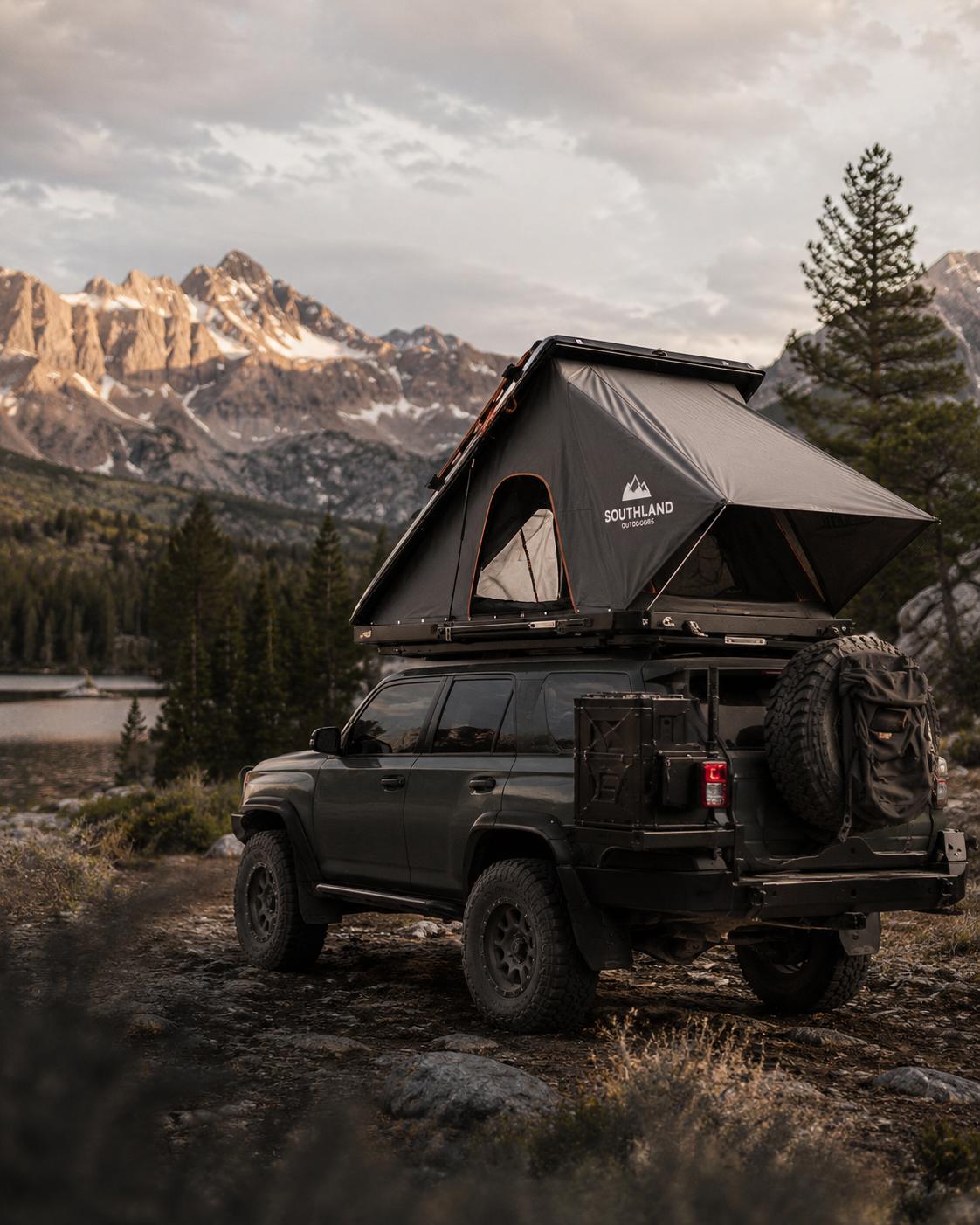 Rooftop tent mounted on a four wheel drive vehicle in a remote landscape